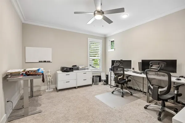 a view of a workspace with furniture and a window