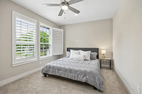 a bedroom with a bed and window