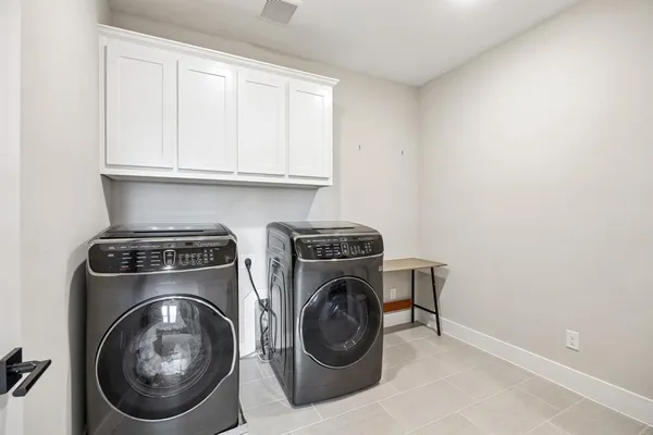 a utility room with sink dryer and washer
