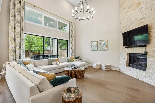 a living room with furniture a flat screen tv and a fireplace