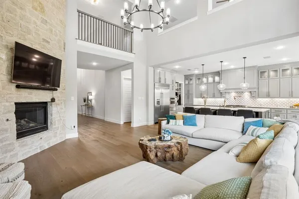 a living room with furniture a flat screen tv and a fireplace