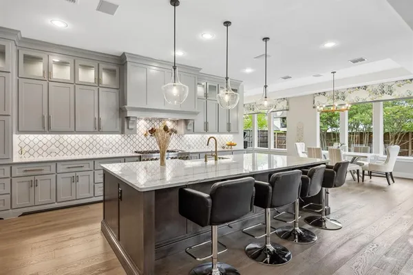 a kitchen with center island cabinets and wooden floor