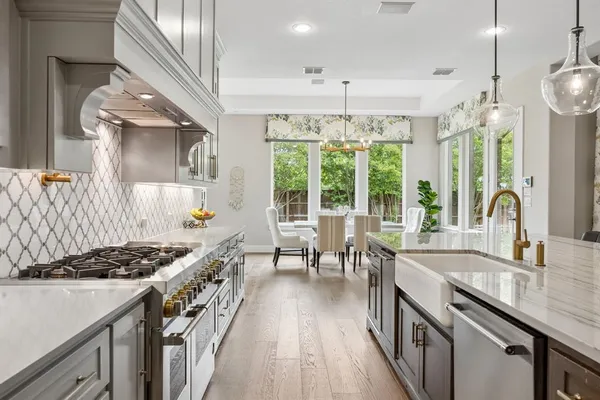 a kitchen with counter top space a sink appliances and cabinets