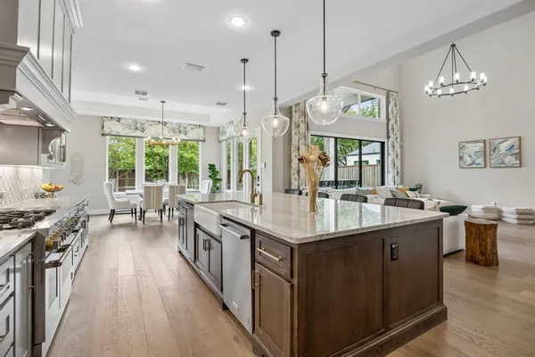 a kitchen with sink stove and refrigerator