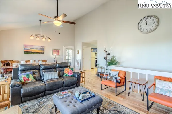 a living room with furniture ceiling fan and a rug