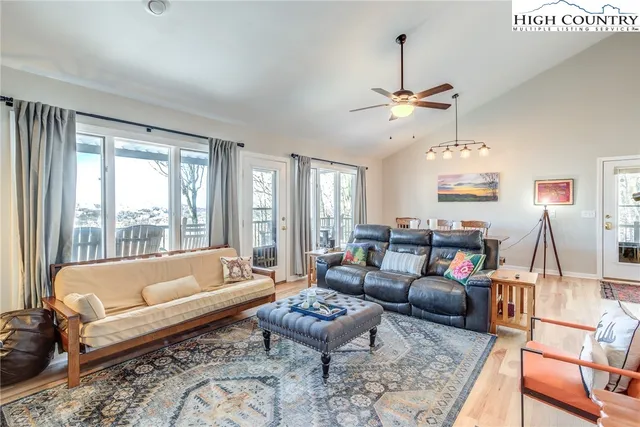 a living room with furniture a fireplace and a potted plant