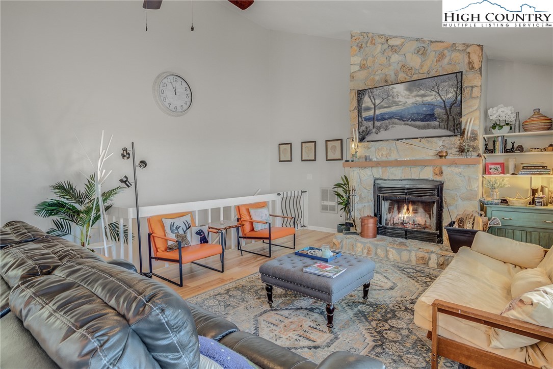 523 Pine Ridge Road Beech Mountain, NC 28604 - Photo 16 of 42 a living room with furniture a fireplace and a potted plant