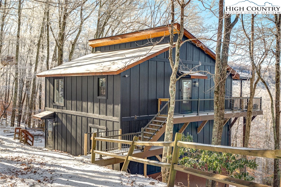523 Pine Ridge Road Beech Mountain, NC 28604 - Photo 2 of 42 a view of a house with a wooden fence