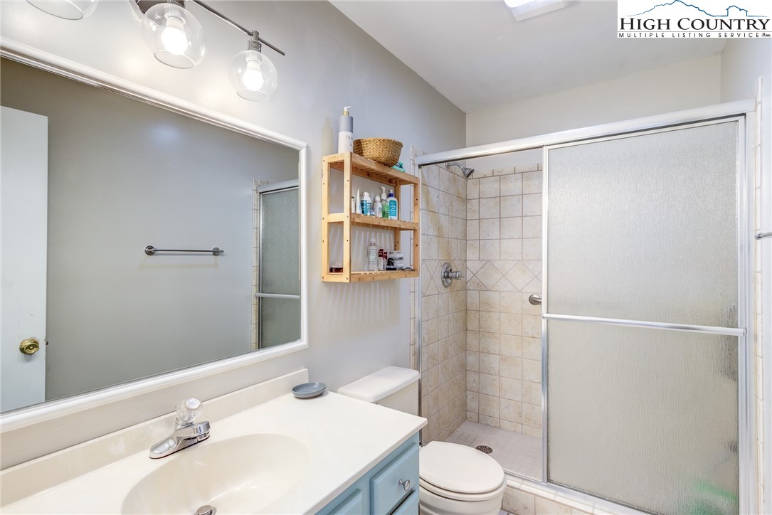 523 Pine Ridge Road Beech Mountain, NC 28604 - Photo 24 of 42 a bathroom with a sink a toilet and shower