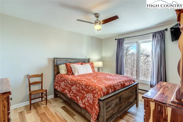 a bedroom with a large bed and a window