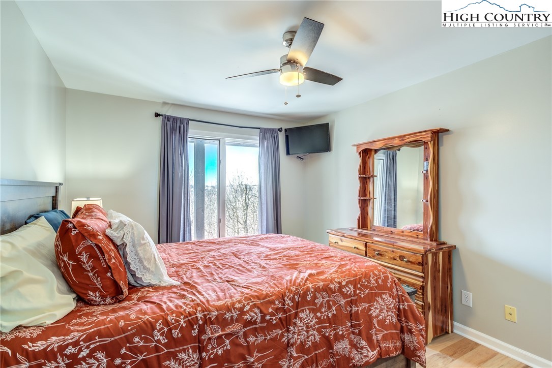 523 Pine Ridge Road Beech Mountain, NC 28604 - Photo 26 of 42 a bedroom with a large bed and a window