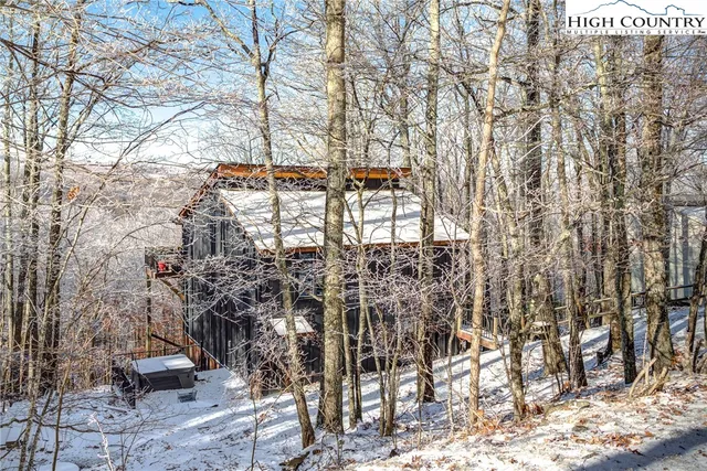 a view of a yard with trees in the background