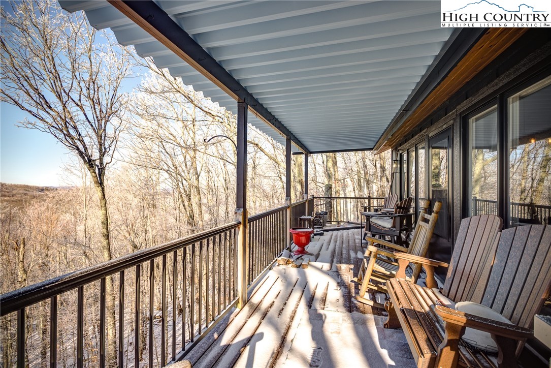 523 Pine Ridge Road Beech Mountain, NC 28604 - Photo 40 of 42 a view of balcony with chairs and wooden fence