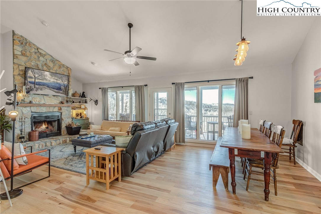 523 Pine Ridge Road Beech Mountain, NC 28604 - Photo 10 of 42 a living room with fireplace furniture and a wooden floor