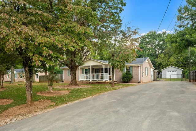 a front view of a house with a garden