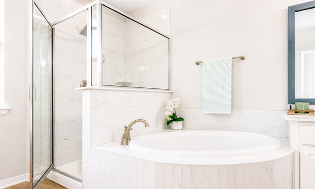 1928 Lakeside Ranch Road Georgetown, TX 78633 - Photo 21 of 37 Indulge in a tranquil bathing experience with this deep soaking tub and sleek glass shower enclosure.