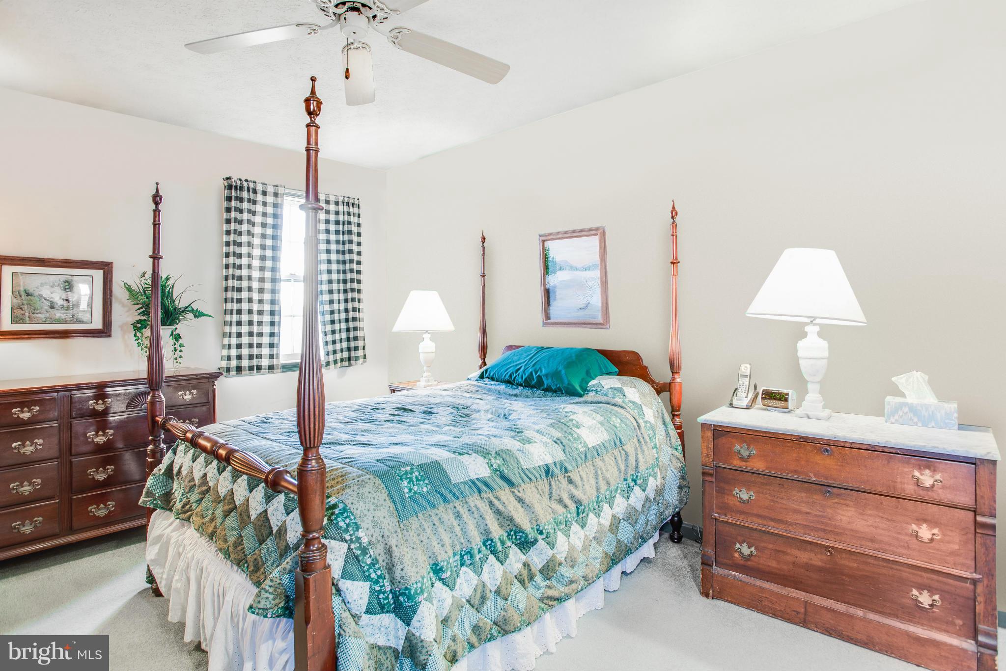 19003 Graystone Road White Hall, MD 21161 - Photo 13 of 21 a bedroom with a bed and a chandelier