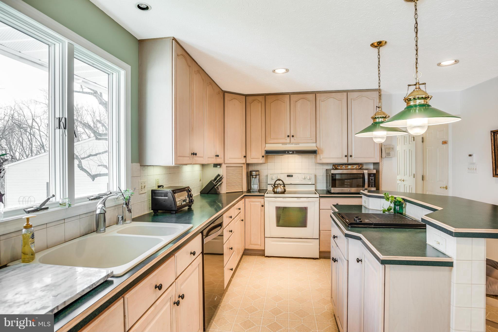 19003 Graystone Road White Hall, MD 21161 - Photo 6 of 21 a kitchen with a sink a stove cabinets and a wooden floor