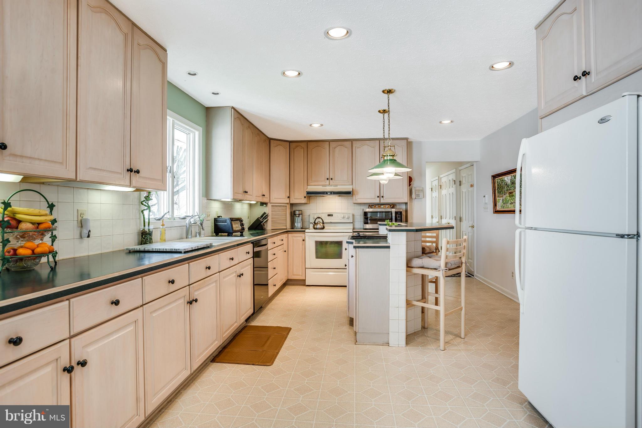 19003 Graystone Road White Hall, MD 21161 - Photo 7 of 21 a kitchen with white cabinets and stainless steel appliances