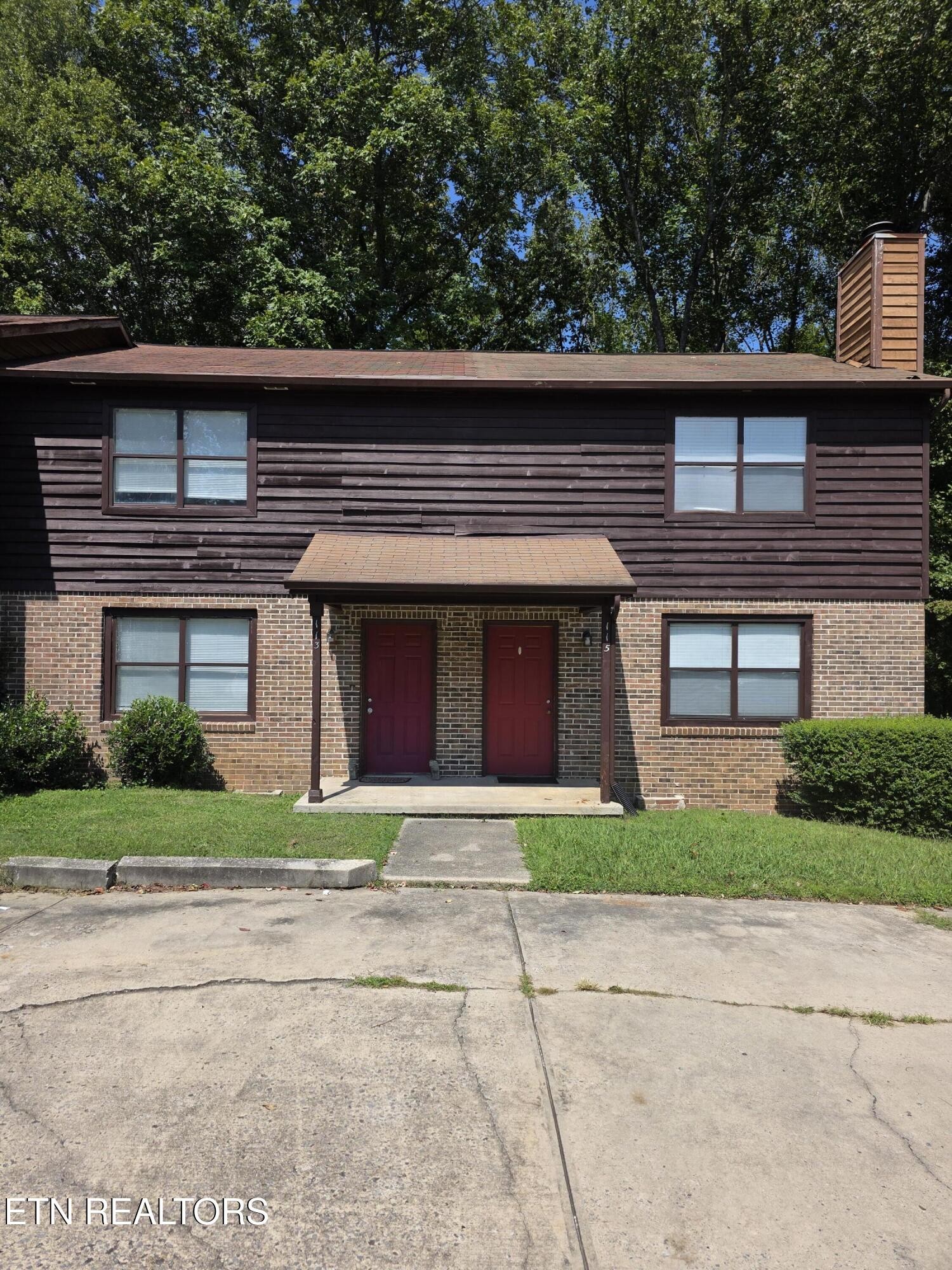 113 High Point Lane Oak Ridge, TN 37830 - Photo 2 of 24 a front view of a house with a yard and garage