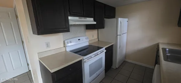 a kitchen with a stove and a refrigerator