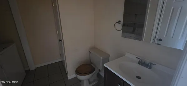 a bathroom with a sink toilet and a mirror