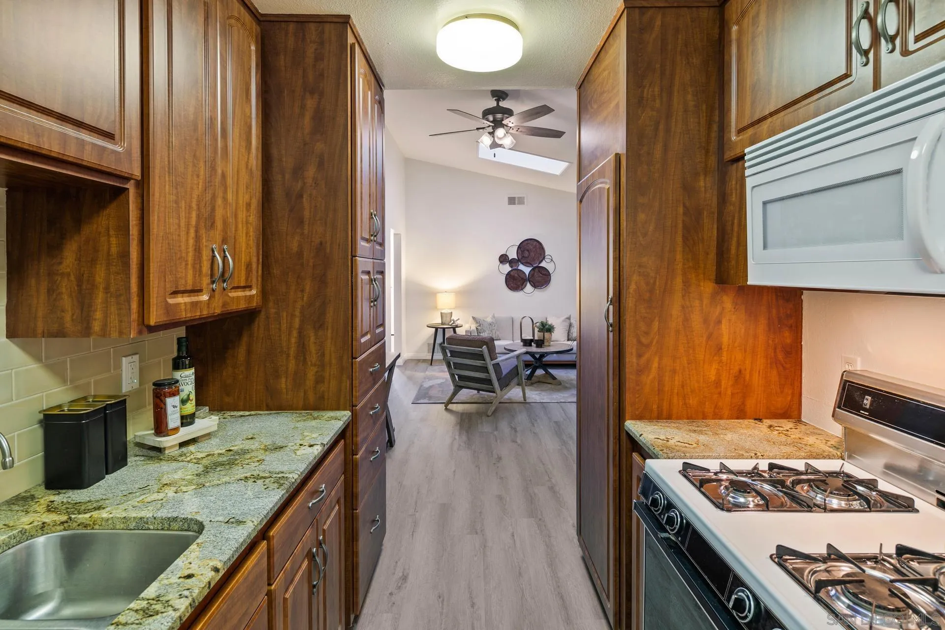 916 Crest Drive Encinitas, CA 92024 - Photo 24 of 47 a kitchen with a stove and a wooden cabinets