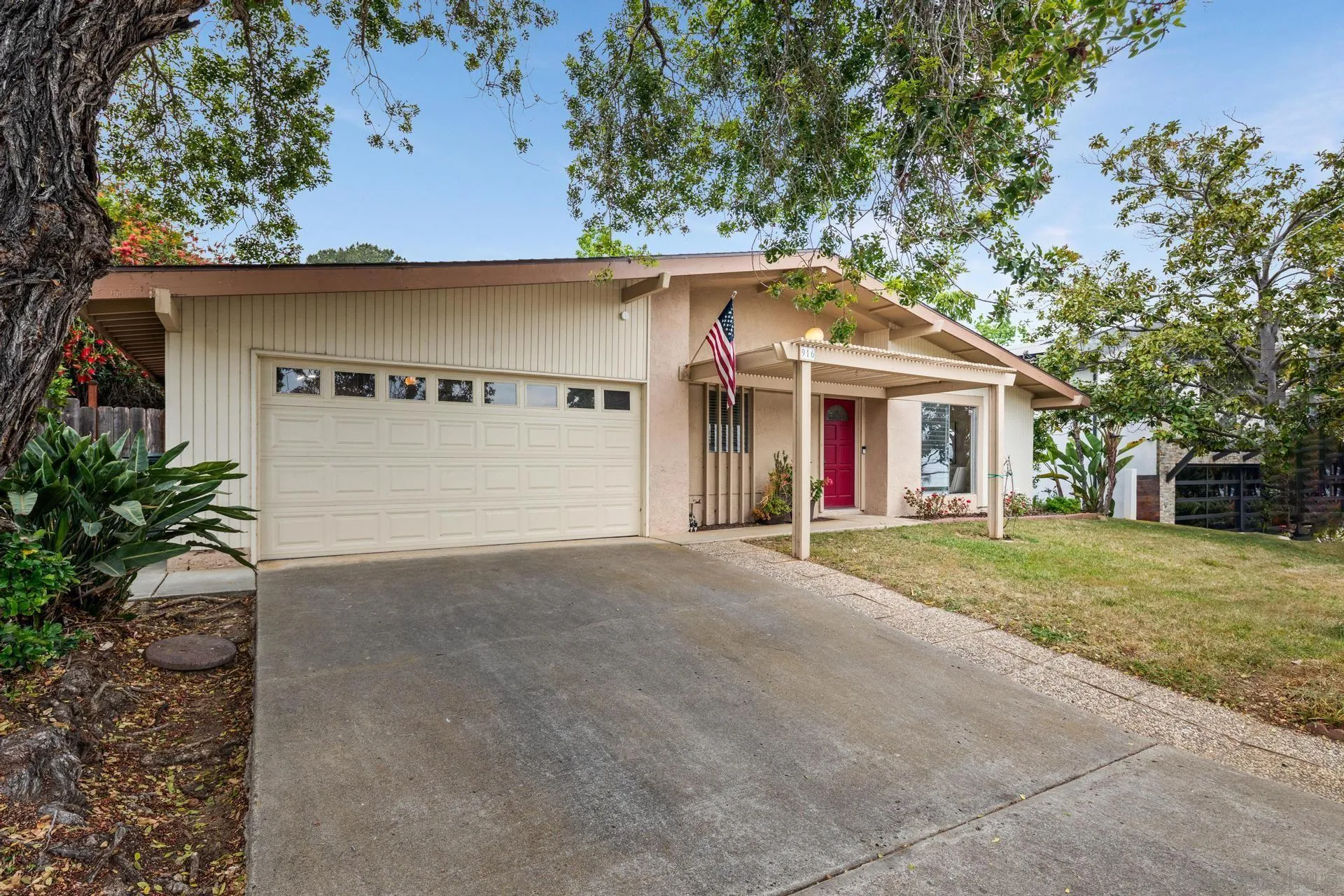 916 Crest Drive Encinitas, CA 92024 - Photo 41 of 47 a view of large white house with large windows and a small yard