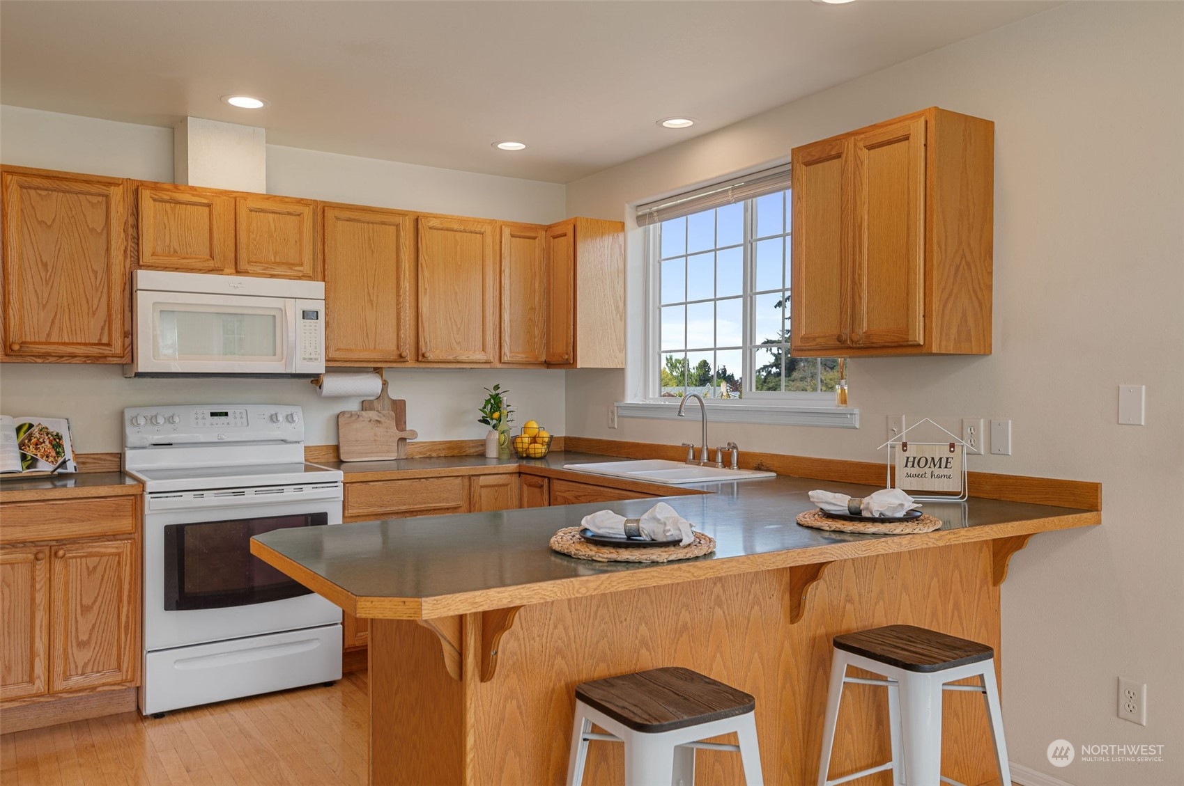 600 North Priest Road Sequim, WA 98382 - Photo 24 of 40 a kitchen with a stove a sink and a refrigerator