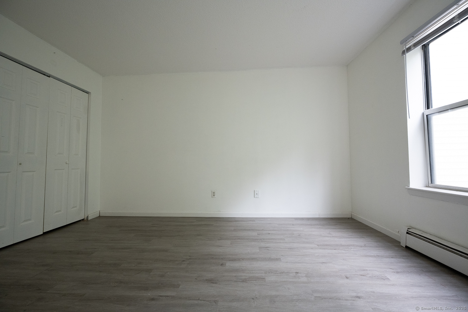 346 Forbes Avenue, Unit 346 New Haven, CT 06512 - Photo 8 of 15 an empty room with wooden floor and windows