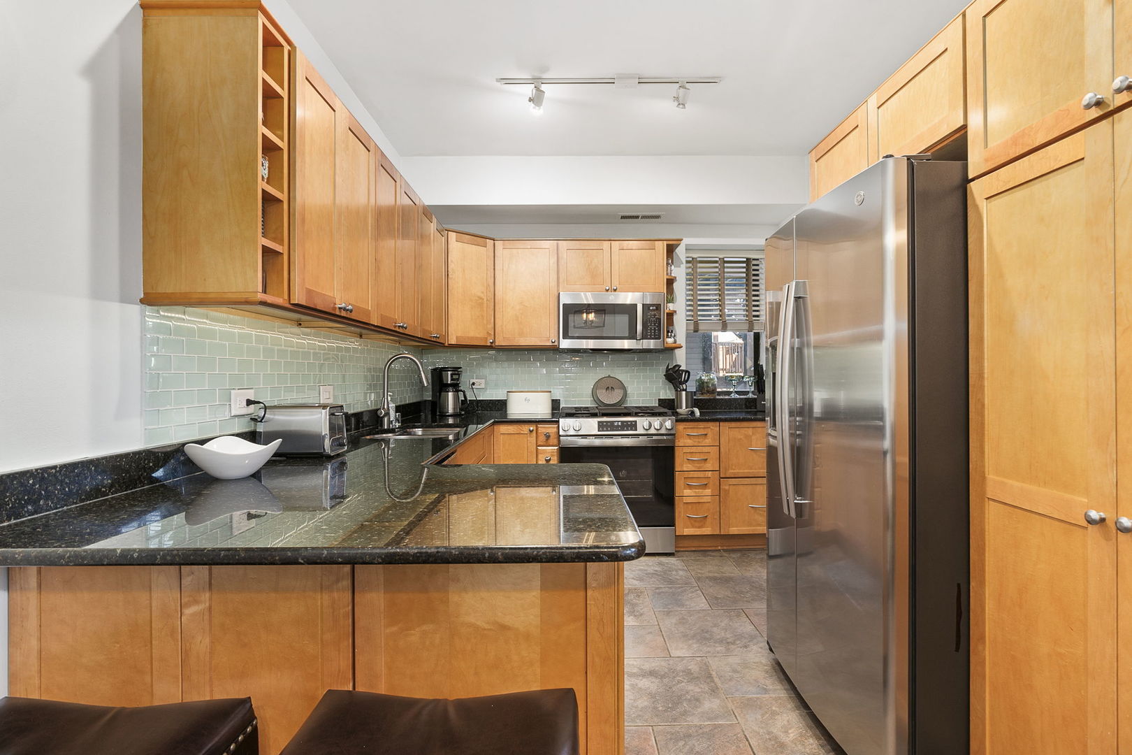 4429 North Beacon Street, Unit 2N Chicago, IL 60640 - Photo 11 of 32 a kitchen with sink a refrigerator and cabinets
