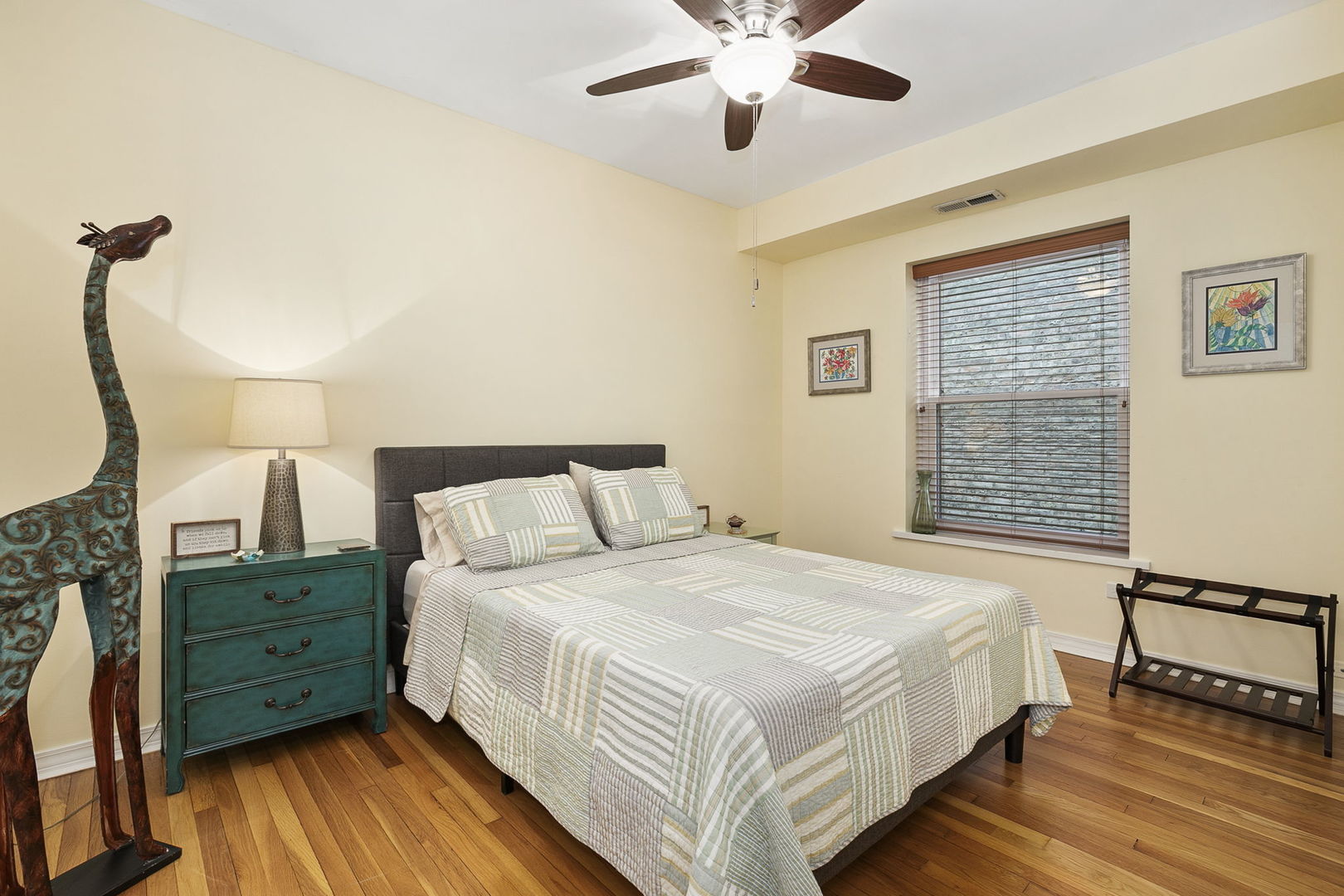 4429 North Beacon Street, Unit 2N Chicago, IL 60640 - Photo 24 of 32 a bedroom with a bed and a chandelier