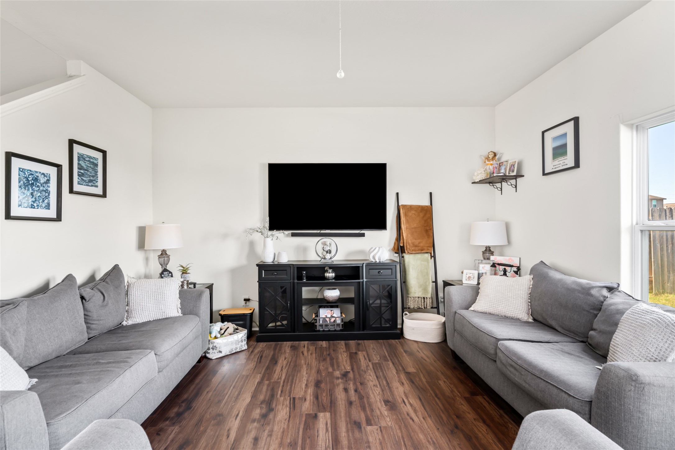2011 Beach Bluff Road Rosenberg, TX 77469 - Photo 11 of 34 This cozy family room, with its wide windows, is the perfect space for creating lasting memories. The abundant natural light highlights the inviting atmosphere, making it an ideal spot for family time, relaxation, and bonding.