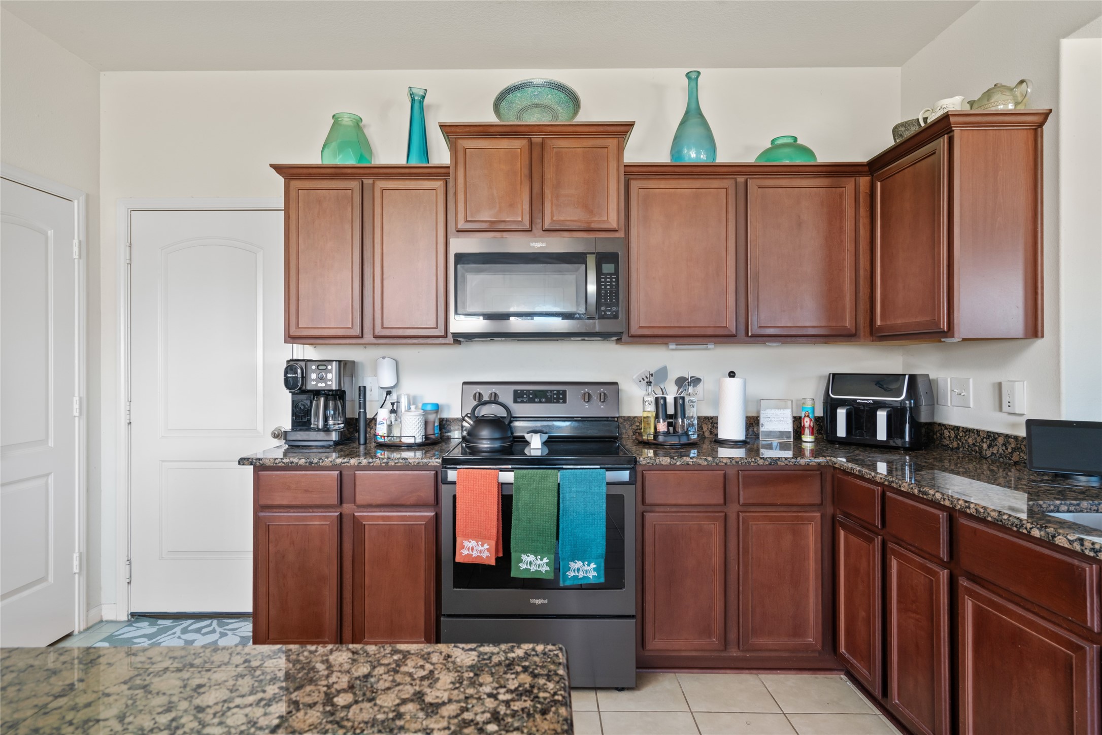 2011 Beach Bluff Road Rosenberg, TX 77469 - Photo 16 of 34 This spacious kitchen is designed for both style and functionality, featuring ample counter space and plenty of cabinetry for storage. It's an ideal space for preparing meals, entertaining guests, and creating lasting memories with family.
