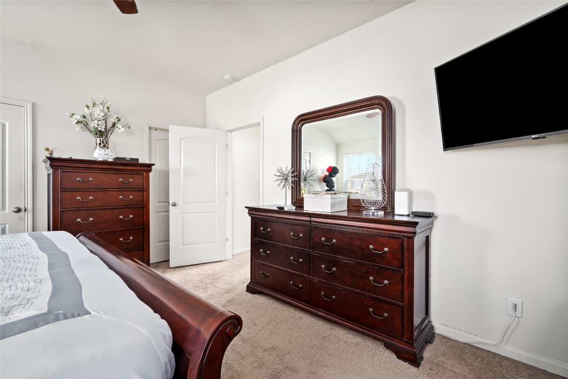 2011 Beach Bluff Road Rosenberg, TX 77469 - Photo 20 of 34 a bedroom with a bed and a flat tv screen on dresser