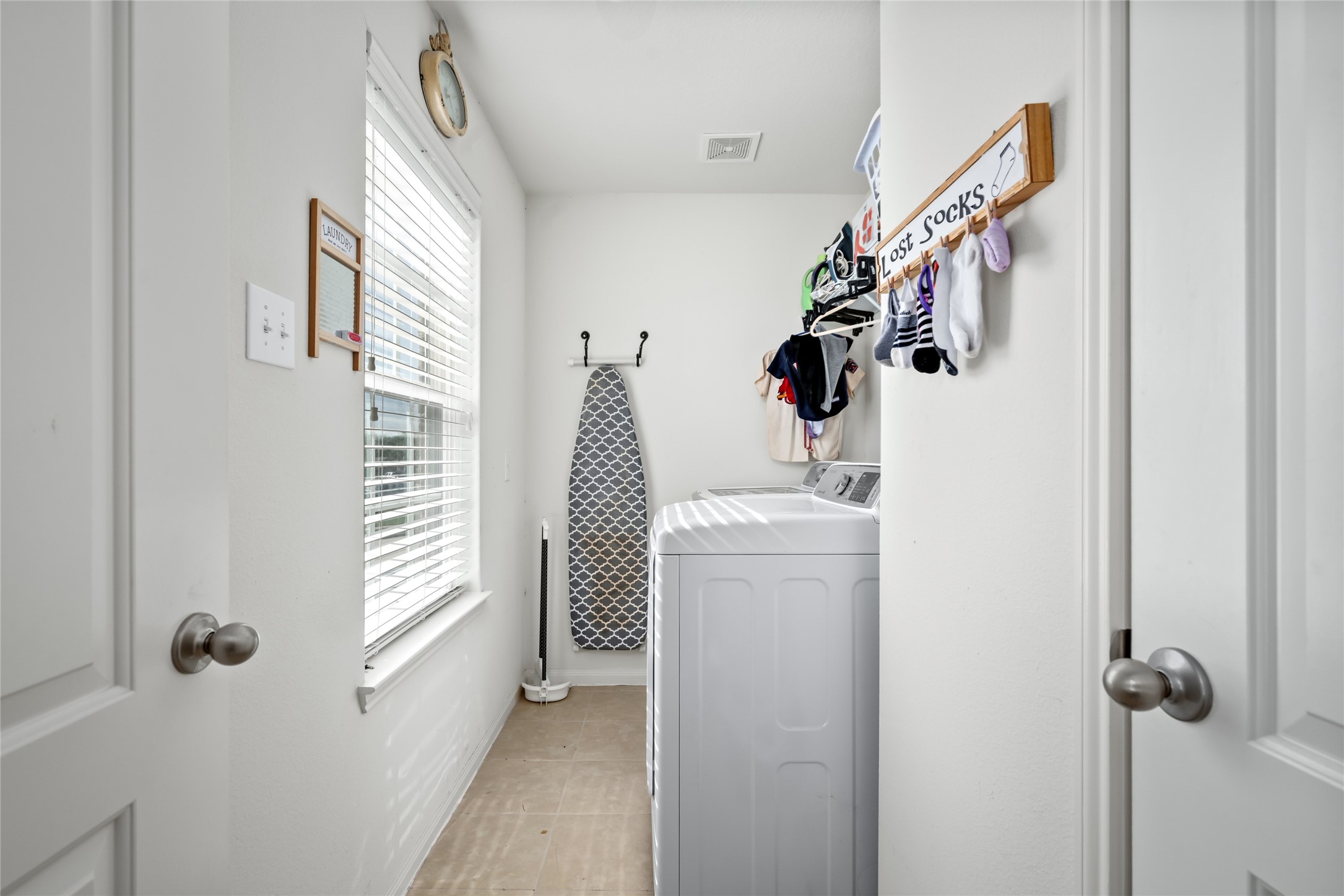2011 Beach Bluff Road Rosenberg, TX 77469 - Photo 28 of 34 This compact utility room is efficiently designed, offering just the right amount of space for laundry essentials and quick storage. It’s a practical area that keeps chores organized without taking up too much room.