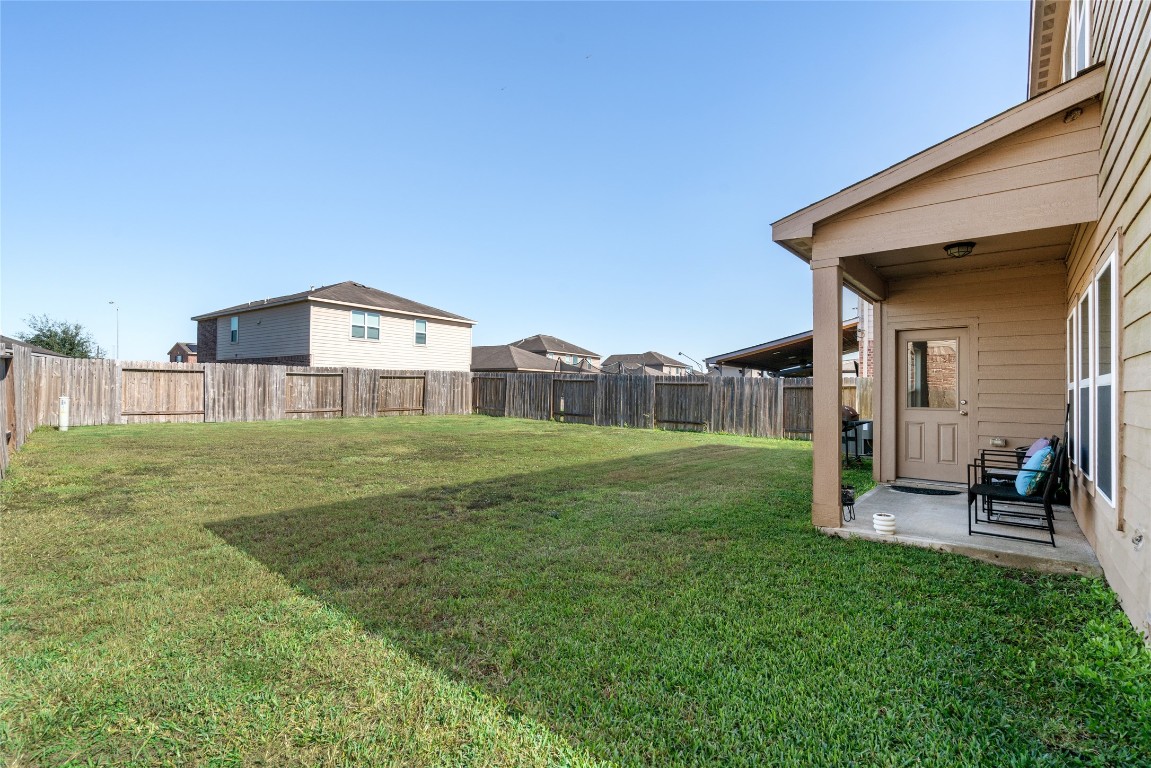 2011 Beach Bluff Road Rosenberg, TX 77469 - Photo 32 of 34 a view of a house with a yard and sitting area