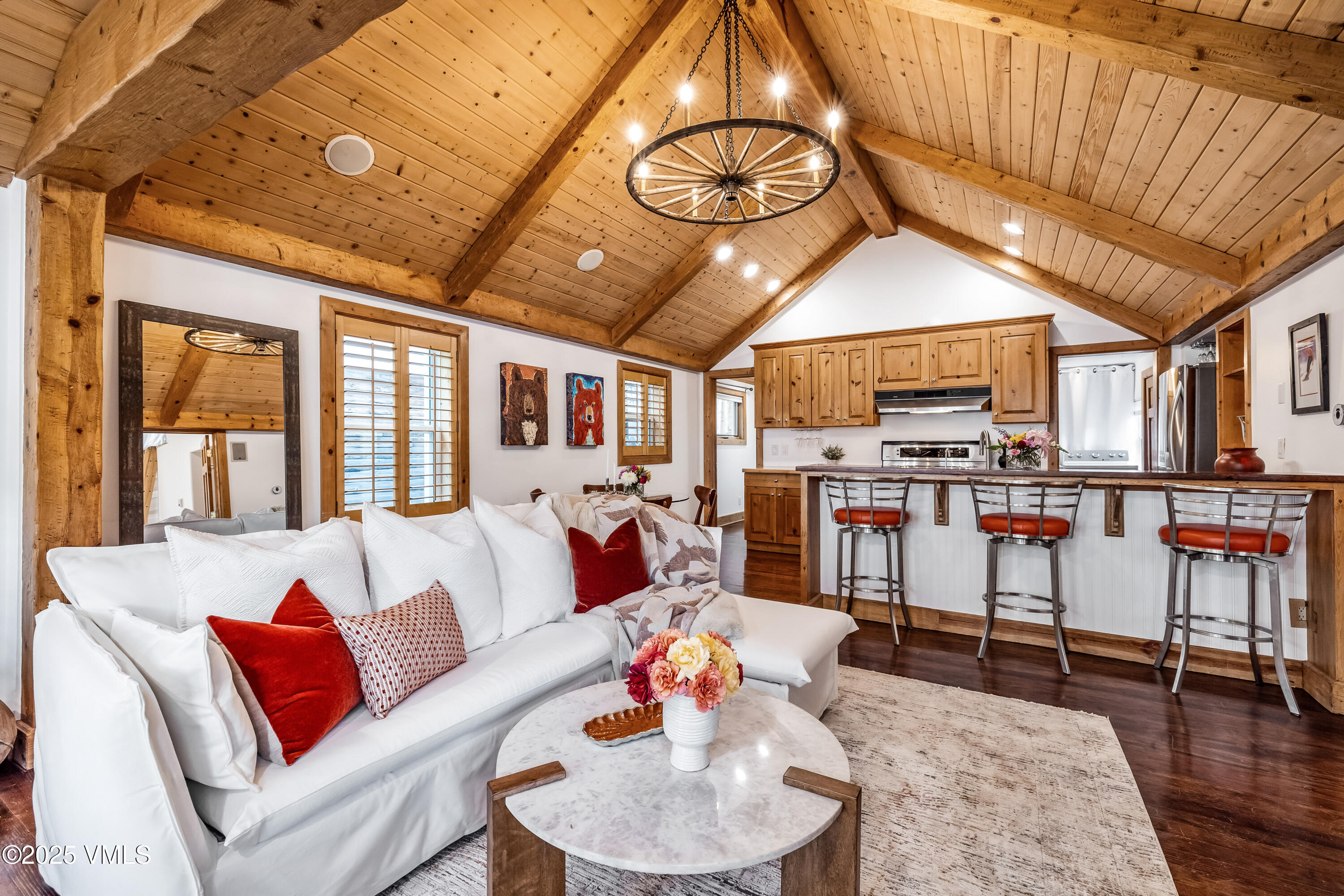 a living room with furniture and kitchen view