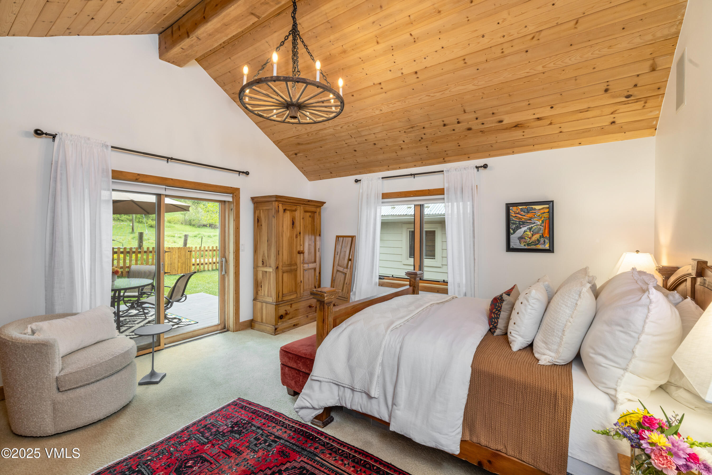 473 Pine Street Minturn, CO 81645 - Photo 3 of 26 a spacious bedroom with a bed couch and a window