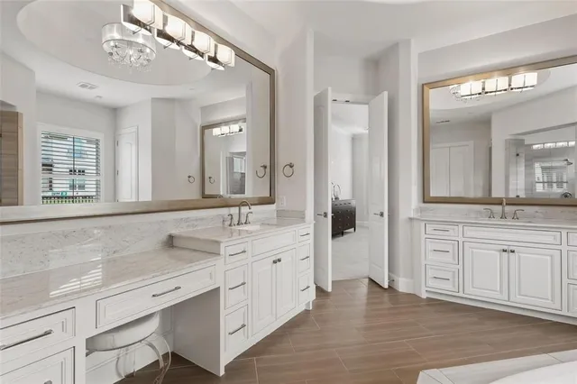 a spacious bathroom with a granite countertop sink mirror and a