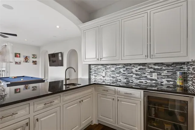 a kitchen with granite countertop white cabinets and white appliances