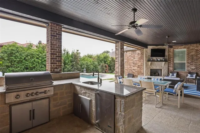 a open kitchen with stainless steel appliances granite countertop a sink a stove and a refrigerator