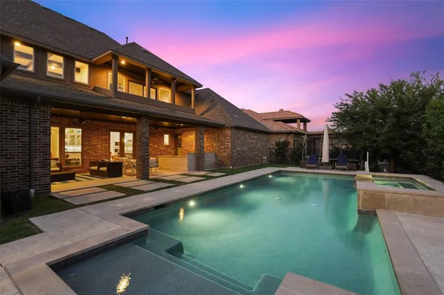 a view of a house with swimming pool and sitting area