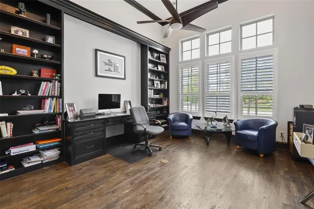 a livingroom with workspace and a window