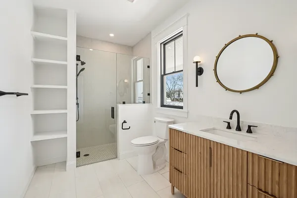 a bathroom with a sink a toilet and a mirror