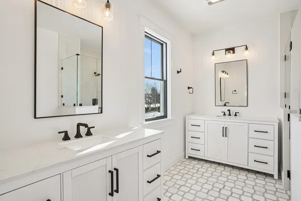 a bathroom with a double vanity sink mirror and