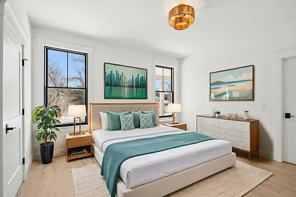 a bedroom with a bed and a chandelier