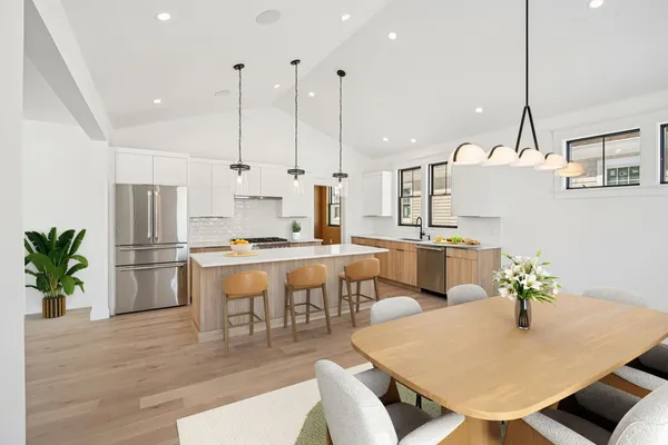 a large kitchen with a table and chairs