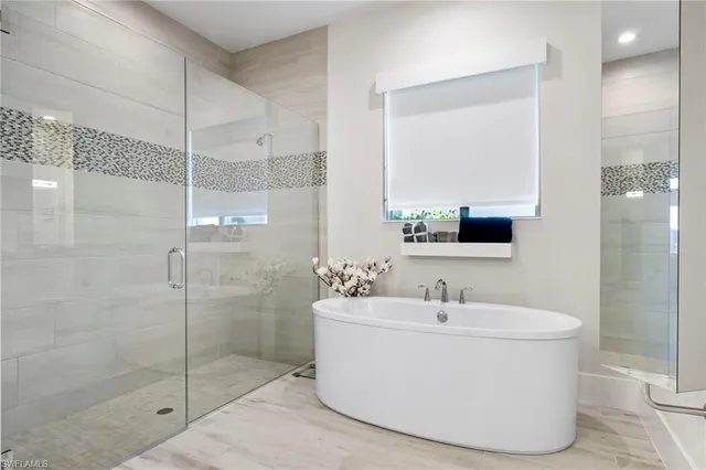 a white bath tub sitting next to a white sink