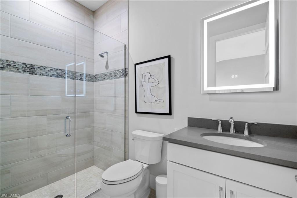 6136 Rodney Bay Lane Naples, FL 34113 - Photo 19 of 29 a bathroom with a toilet sink and shower